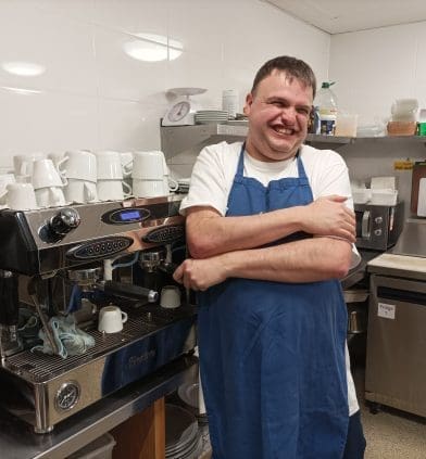 Jason in front of a coffee machine at Upmo Cafe